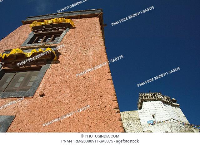 Low angle view of a gompa with a fort in the background, Namgyal Tsemo Gompa, Victory Fort, Leh, Ladakh, Jammu and Kashmir, India