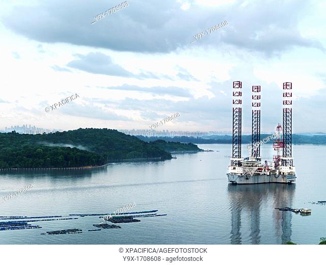 A scenic view of an oil rig located along side a fish farm off of Johor's coast