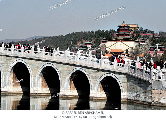 BEIJING - MAR 14:Visitors cross over the Seventeen-Arch Bridge at The Summer Palace in Beijing China on March 14 2009 The Summer Palace is the best preserved...