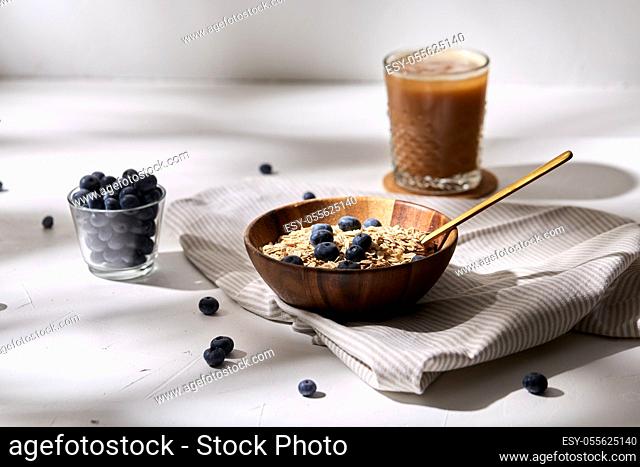 oatmeal with blueberries, spoon and coffee