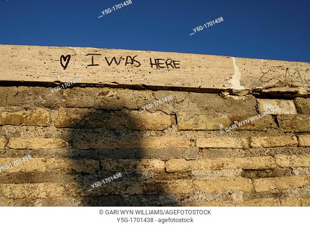 i was here and love heart graffiti on brick wall
