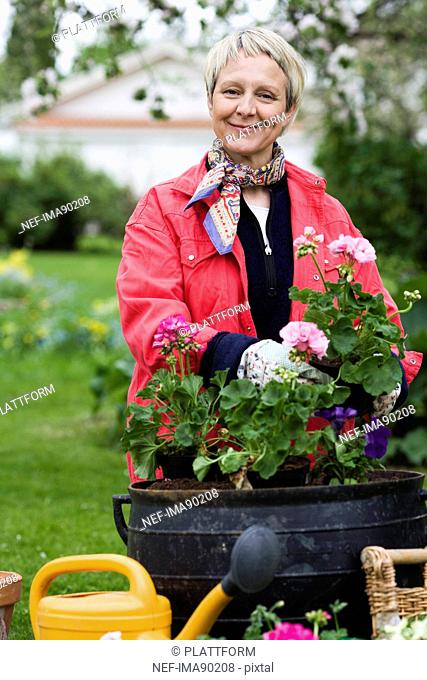 A woman planting flowers, Sweden