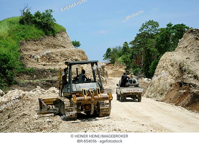 Earth mover building a road for the refinery and harbour area of the Ramu Nickel Mine, chinese mining company, Basamuk, Papua New Guinea, Melanesia
