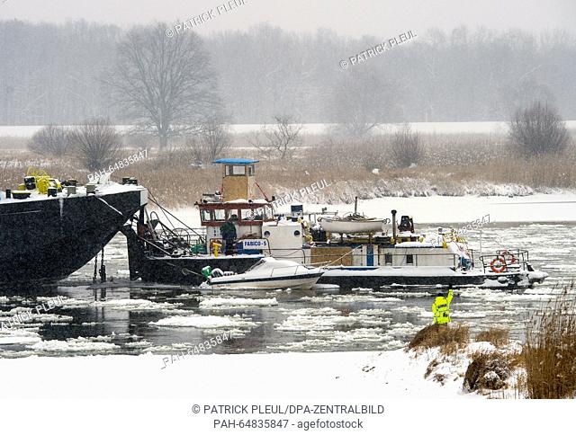 A Polish pushed boat convoy stuck on a sandbank among the ice floes on the German-Polish border river Oder, near Reitwein, Germany, 6 January 2016