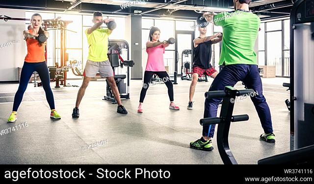 People exercising together with gym equipment