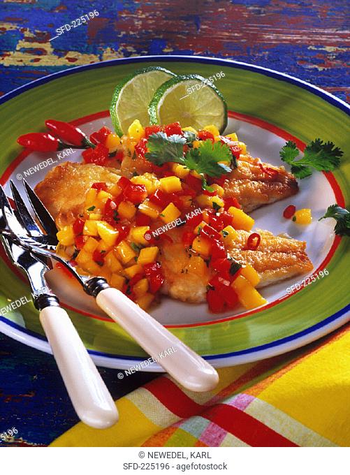 Red snapper with mango salsa and lime slices