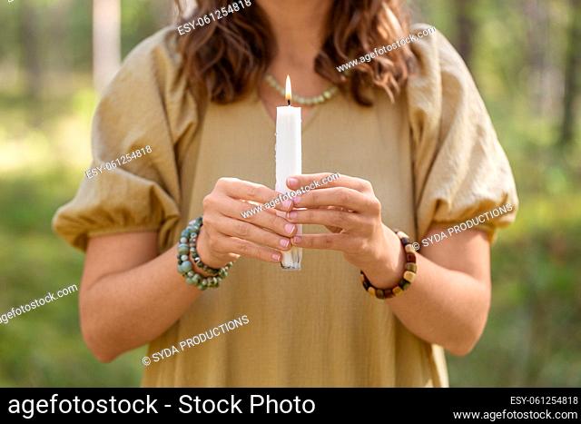 woman with candle performing magic ritual