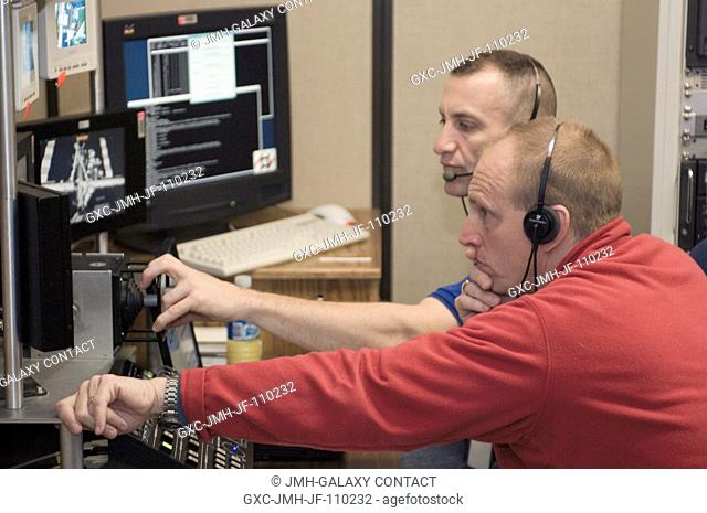 Astronauts Clayton C. Anderson (foreground), Expedition 15 flight engineer, and Charles O. Hobaugh, STS-118 pilot, use the virtual reality lab at the Johnson...