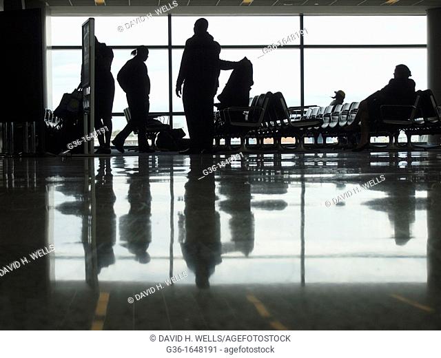 Silhouettes of travelers in an airport terminal in Newark, New Jersey, United States