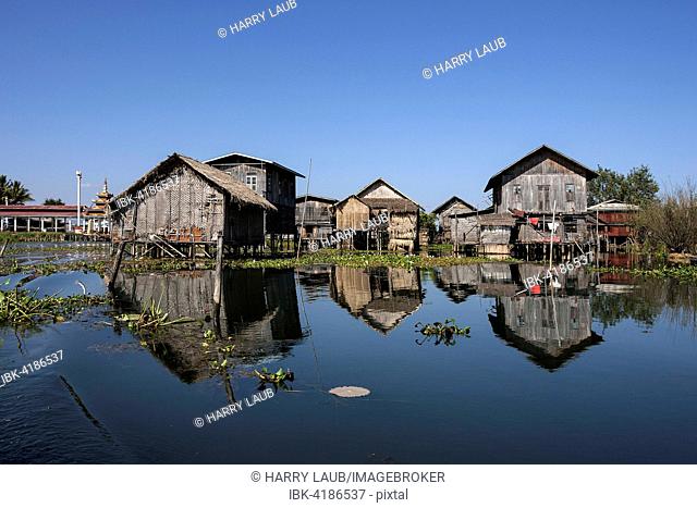 Traditional stilt houses in Inle Lake, reflection in the water, Shan State, Myanmar