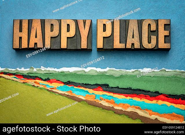 happy place - word abstract in vintage letterpress wood type against abstract paper river landscape, joy and happiness concept - a memory, situation
