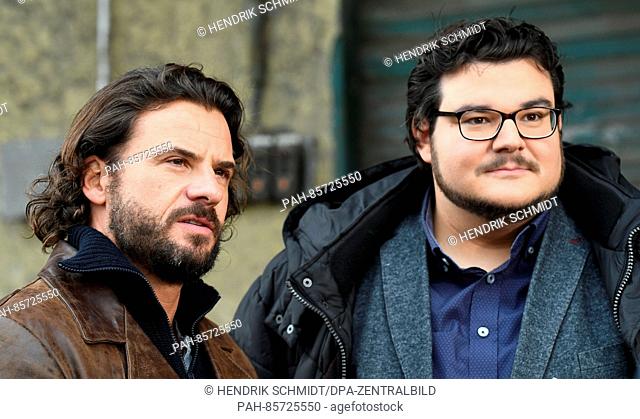Actors Stephan Luca (L) and Axel Ranisch stand on the set for the ARD crime show 'Zorn' in the harbor of Halle/Saale, Germany, 17 November 2016