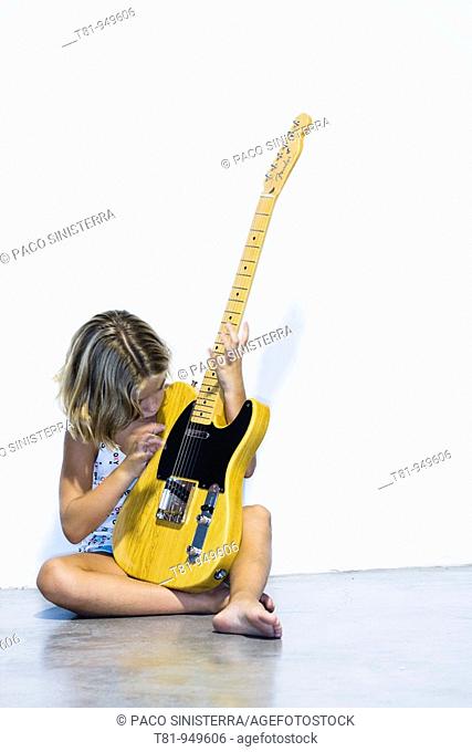girl playing electric guitar