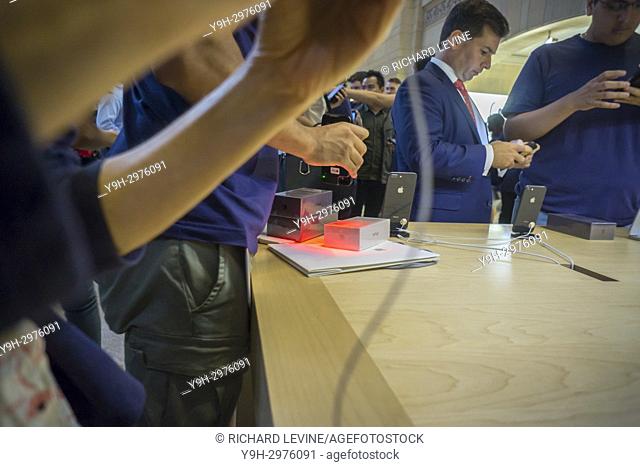 An Apple employee scans an iPhone 8 purchase in the Apple store in Grand Central Terminal in New York on Friday, September 22, 2017