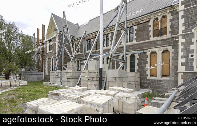 CHRISTCHURCH, NEW ZEALAND - December 03 2019: cityscape with metal scaffoldings of monumental Victorian edifice rebuilding site at The Arts Centre