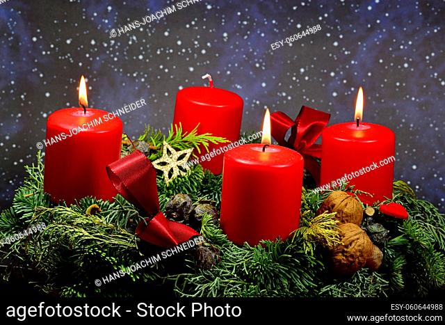 . advent wreath with 3 burning candles