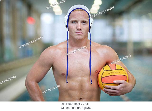 Water polo player outside pool holding ball
