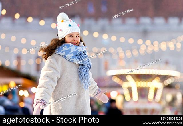 happy little girl at christmas amusement park