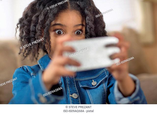 Close up of cute girl looking surprised for smartphone selfie
