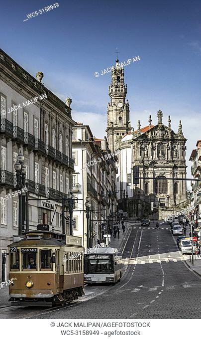 old town street view of porto portugal with tram and bus and landmark clerigos church