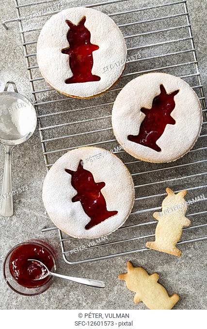 Jam cookies with Easter bunny motifs on a cooling grid