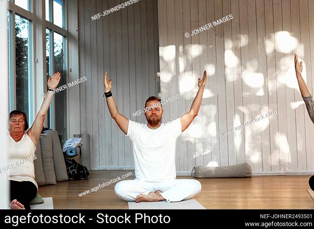 People practicing yoga in class