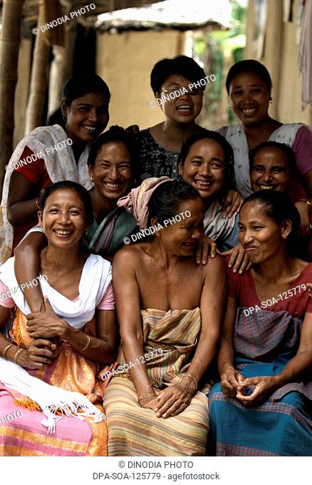 Women seating together and smiling ; Bongaigaon ; Assam ; India