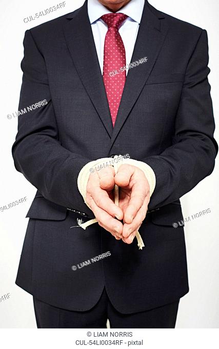 Businessman with hands tied