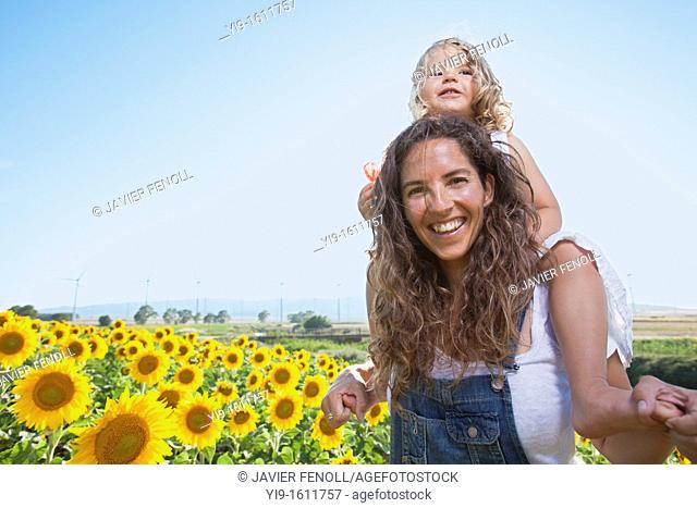 mother and daughter in a field of sunflowers