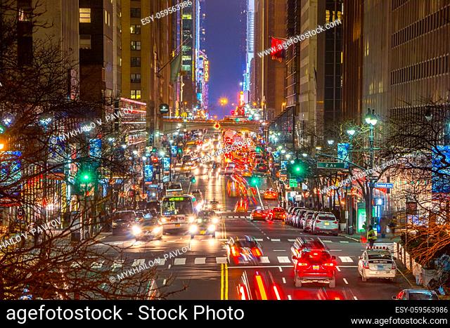 NEW YORK CITY, UNITED STATES — DECEMBER 22, 2015. Night Traffic on 42nd Manhattan Street. Lights of car headlights, traffic lights and street lamps
