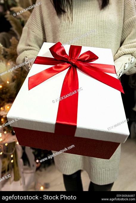 Present held in womans hand. Merry Christmas and Happy New Year concept