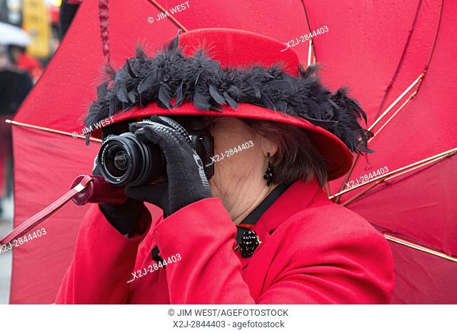 Detroit, Michigan - A photographer at the Marche du Nain Rouge, a parade that celebrates the coming of spring