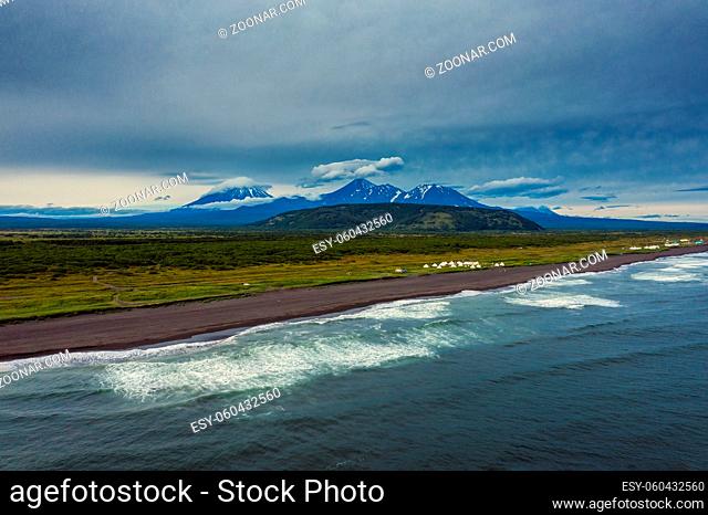 Aerial view of Khalaktyrsky beach with black sand and volcano on Kamchatka peninsula, Russia, Pacific ocean