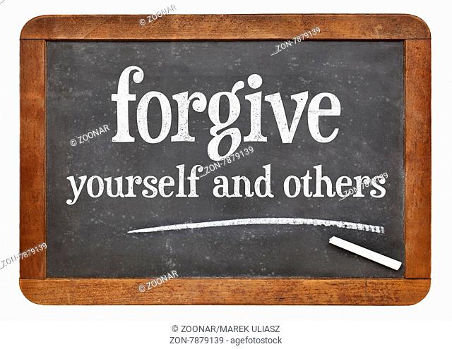 Forgive yourself and others advice - white chalk text n on a vintage slate blackboard
