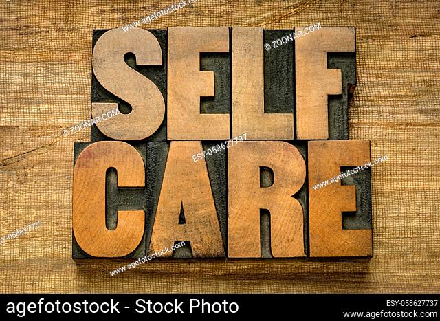 self care word abstract in vintage letterpress wood type on grunge handmade paper - mental, emotional, and physical health concept