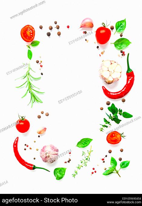 Provence herbs and spices isolated on white background, cherry tomatoes and chilli pepers as a frame for food design. Place for text