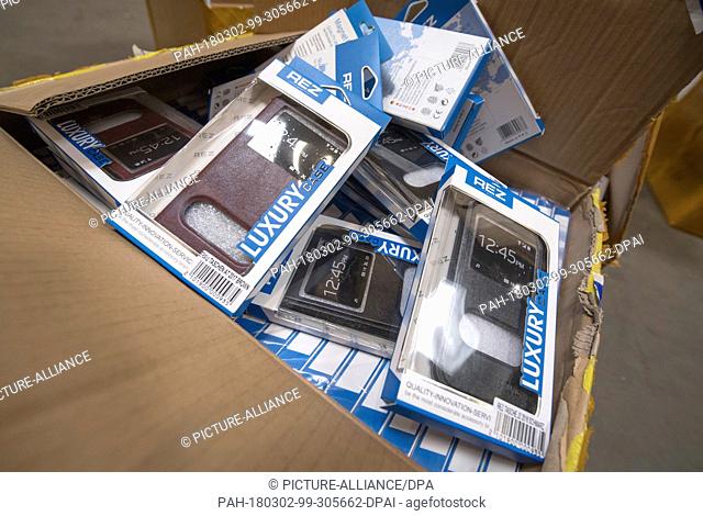 28 February 2018, Germany, Frankfurt: German customs seized fake phone cases at a secret shipping's storage at an industrial estate