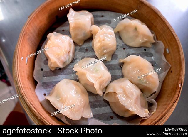 Chinese steamed jiaozi in a bamboo steamer on a table in Taiwan