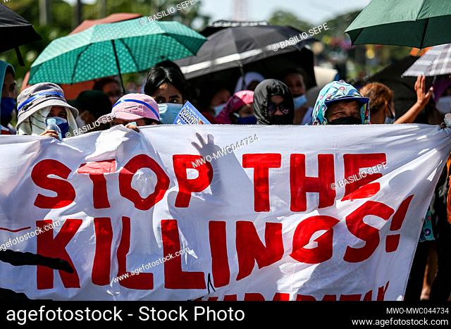 Protesters carry signs during a protest to mark the 73rd International Human Rights Day at the University of the Philippines in Quezon City, Metro Manila