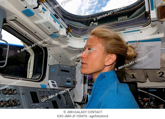 Astronaut Karen Nyberg, STS-124 mission specialist, works the controls on the aft flight deck of Space Shuttle Discovery during flight day two activities