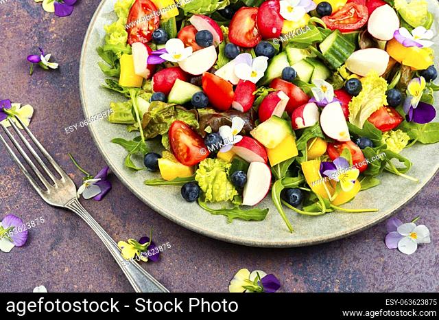 Vegan salad with vegetable and edible flowers. Clean eating