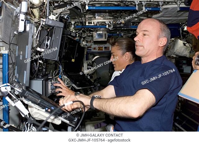 Astronauts Heidemarie M. Stefanyshyn-Piper, STS-115 mission specialist, and astronaut Jeffrey N. Williams, Expedition 13 flight engineer and NASA station...