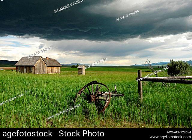 Farm house with storm clouds looming, Chesterfield, Idaho, USA