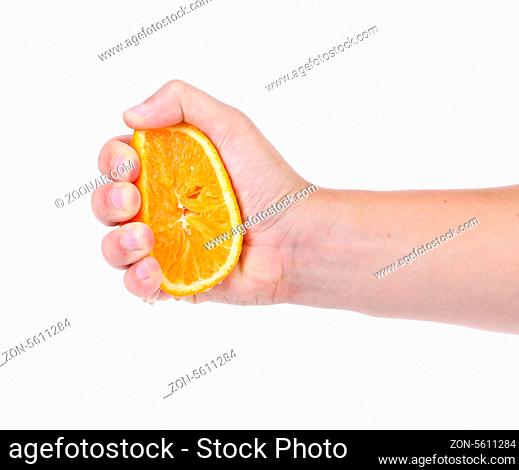 Hand squeeze ripe juicy orange. White background