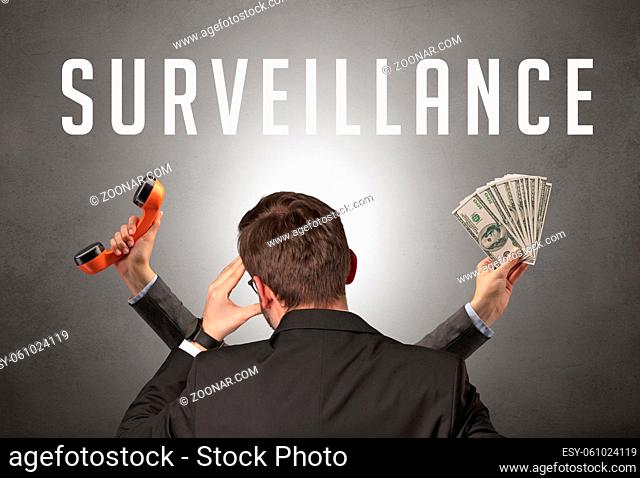 Rear view of a businessman with SURVEILLANCE inscription, cyber security concept