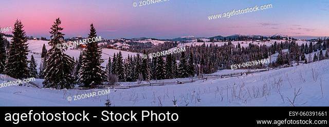 Small and quiet alpine village and winter sunrise snowy mountains around, Voronenko, Carpathian, Ukraine