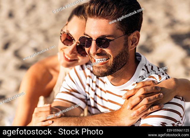 happy couple chilling on summer beach