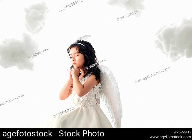 Happy little angel praying