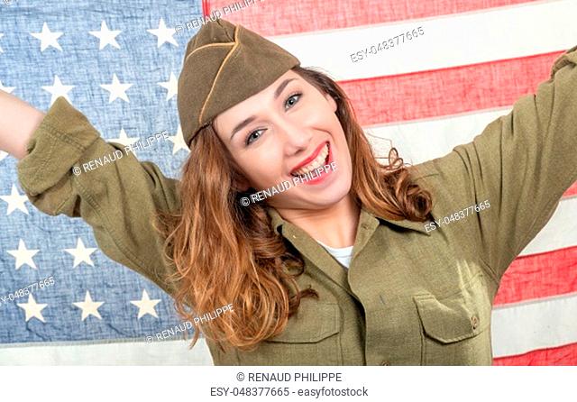pretty young woman in wwii uniform us with an american flag