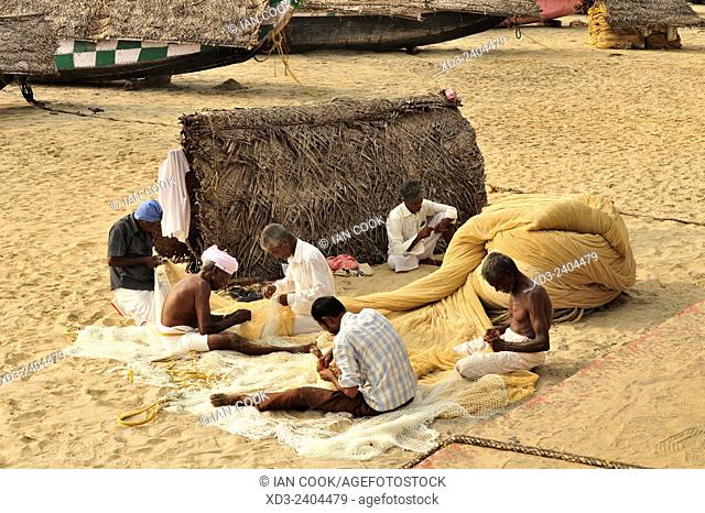 fishermen mending nets, Hawa Beach, Kovalam, Kerala, India